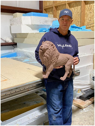 Wyland with lion bronze sculpture in the making